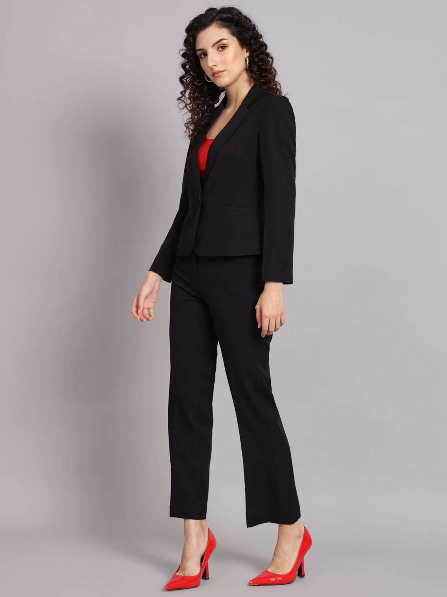 XAYWEAR black blazer for women paired with matching pants and red shoes in professional suit look