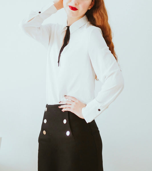 XAYWEAR black skirt mini-skirt with silver buttons worn with white blouse on woman
