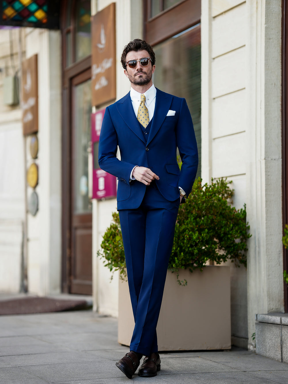 XAYWEAR navy blue suit worn by man standing outdoors showcasing formal wear for men