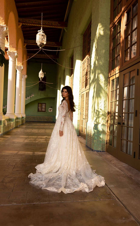 XAYWEAR bridal ball gown with lace sleeves and long train in elegant hallway