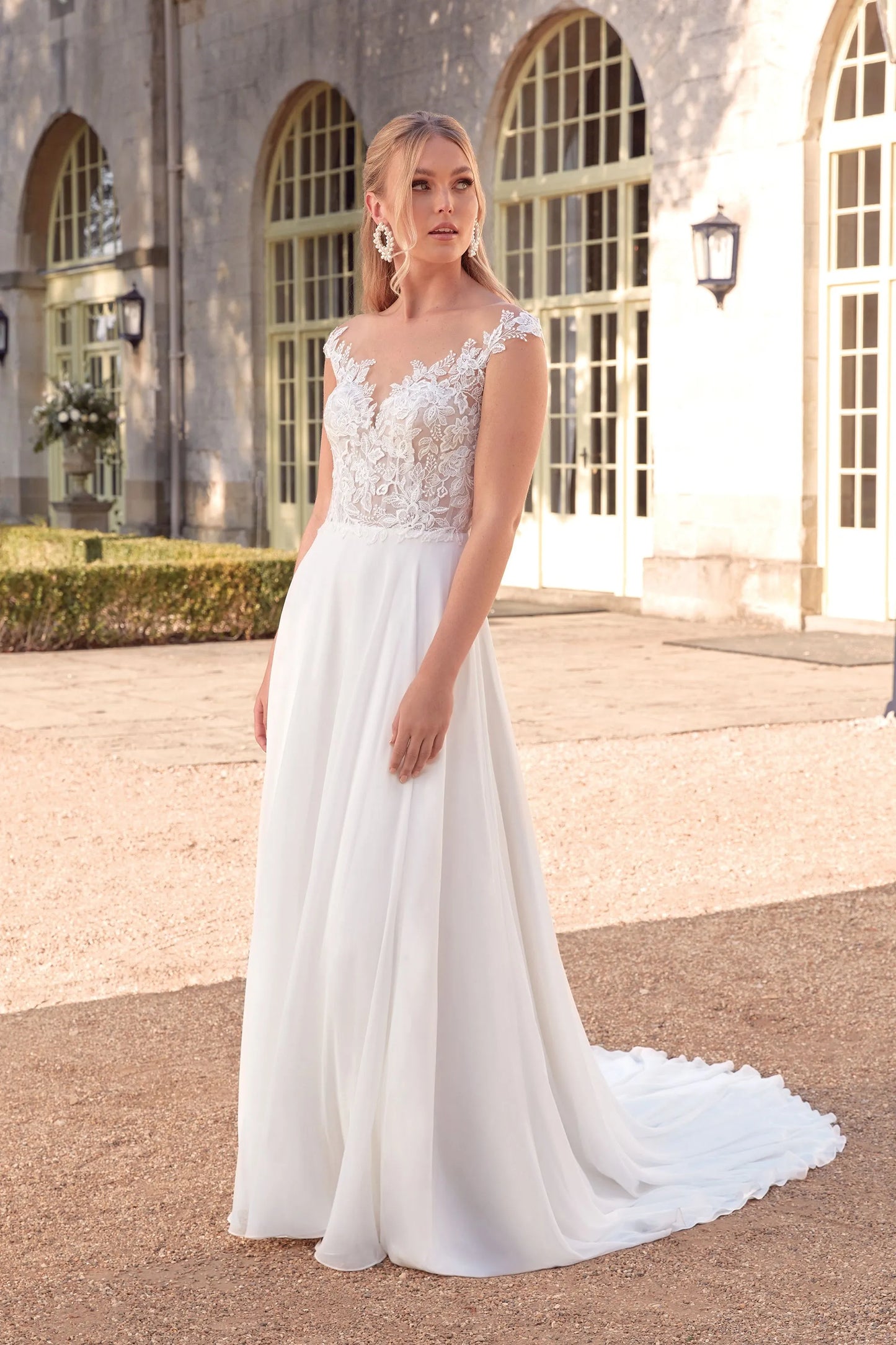 XAYWEAR chiffon wedding dress with lace bodice and flowing skirt worn by a model outdoors