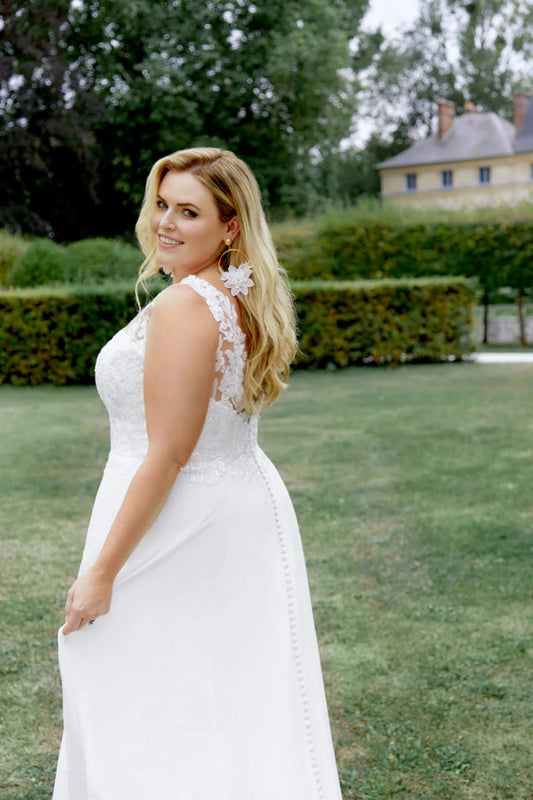 XAYWEAR chiffon wedding gown featuring lace details and buttoned back in outdoor garden setting