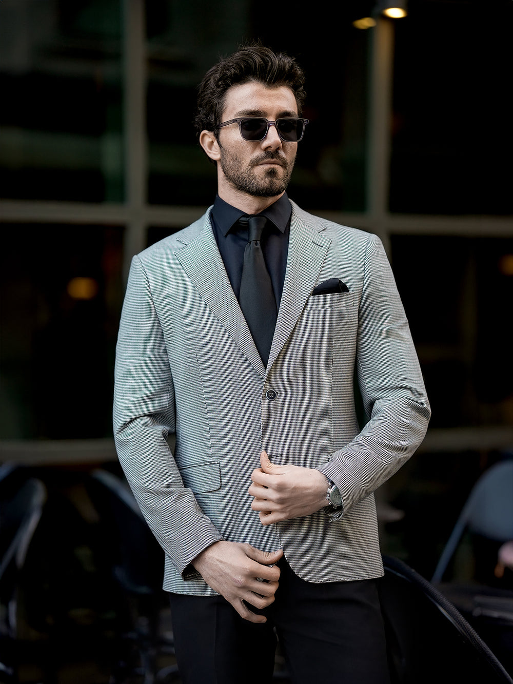 XAYWEAR two piece suit for men in light gray worn with black shirt and tie and sunglasses