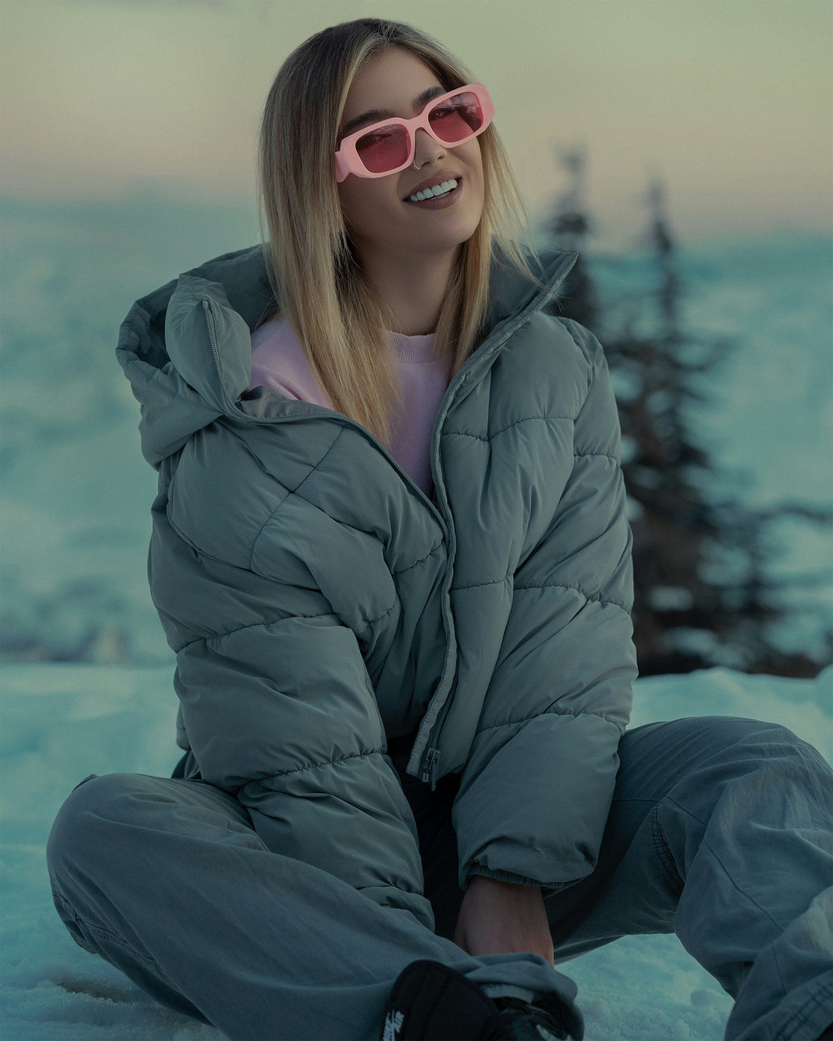 Stylish woman wearing XAYWEAR Ice Puffer Jacket for Extreme Cold in a snowy landscape