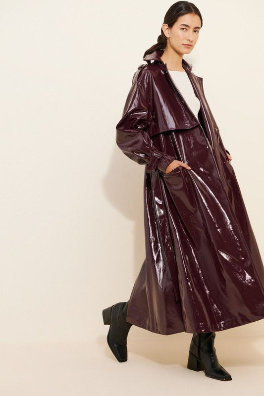 XAYWEAR glossy dark brown leather coat for women styled with black ankle boots