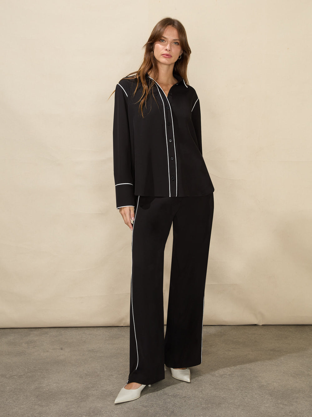 Elegant luxury women's lounge set in black with contrast piping for stylish comfort at home