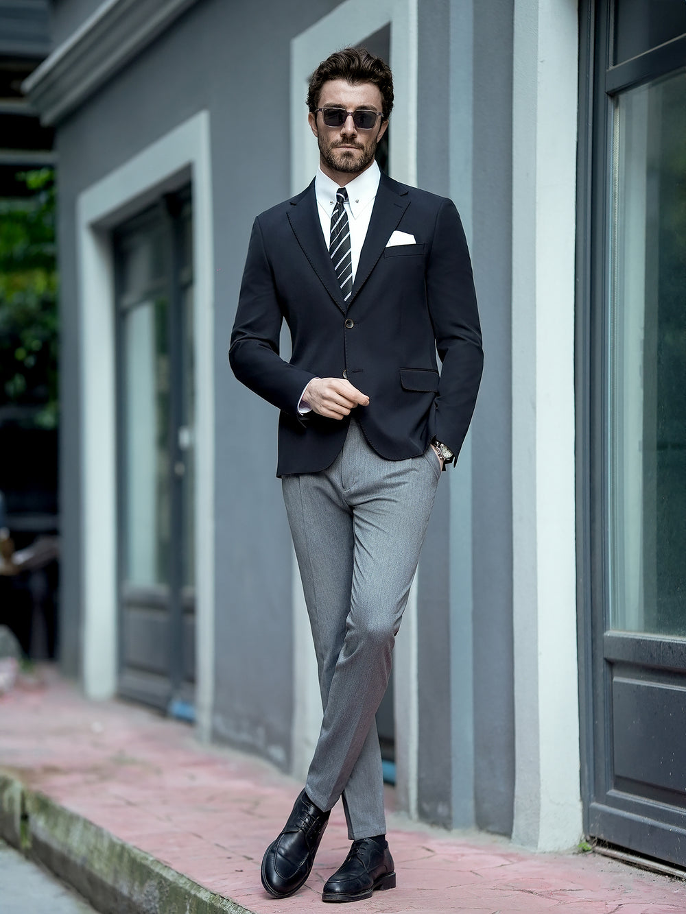 XAYWEAR men business attire with black blazer grey trousers and striped tie for formal occasions