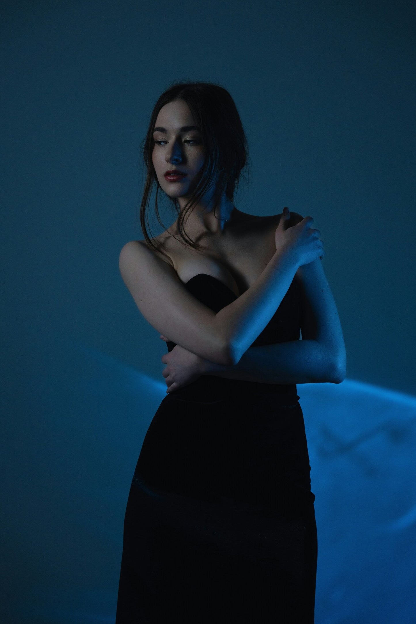 Elegant model wearing a premium black gown with a sleek design and luxurious fabric