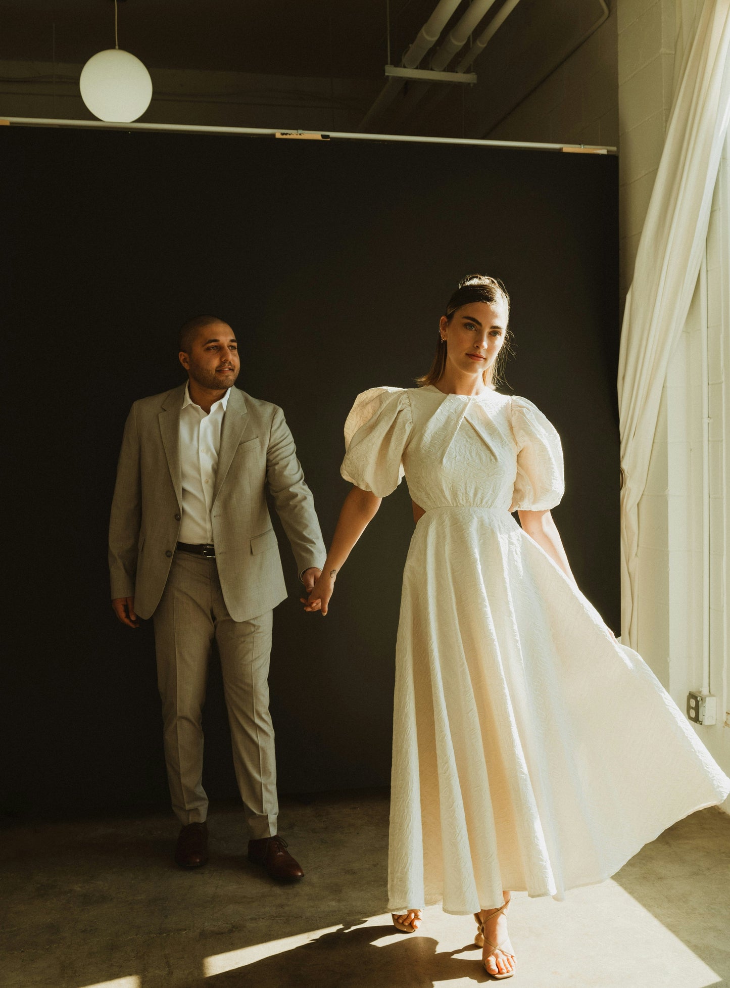 XAYWEAR premium bridal dress with back detail, featuring puff sleeves and a flowing skirt