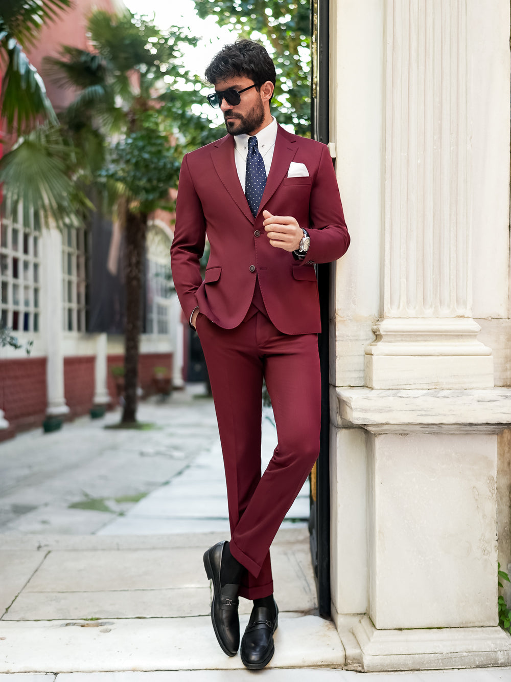 XAYWEAR burgundy suit for men with matching trousers, white shirt, and navy tie outdoors