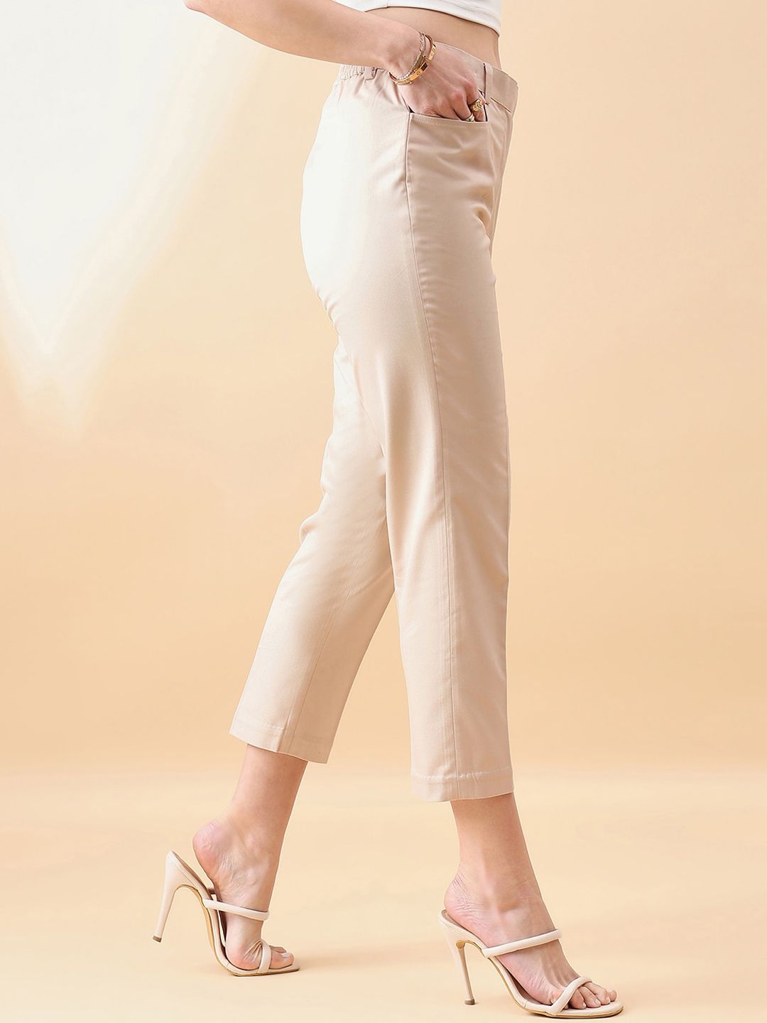 XAYWEAR beige cropped trousers for women styled with high heel sandals and casual top