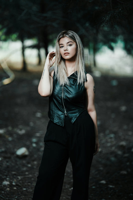 XAYWEAR black leather vest for women styled with black pants in outdoor setting
