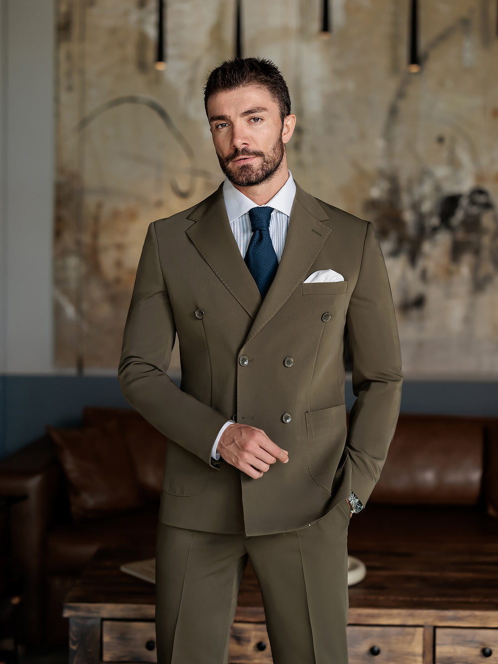 XAYWEAR olive double-breasted suit for men with white shirt and navy tie in modern interior