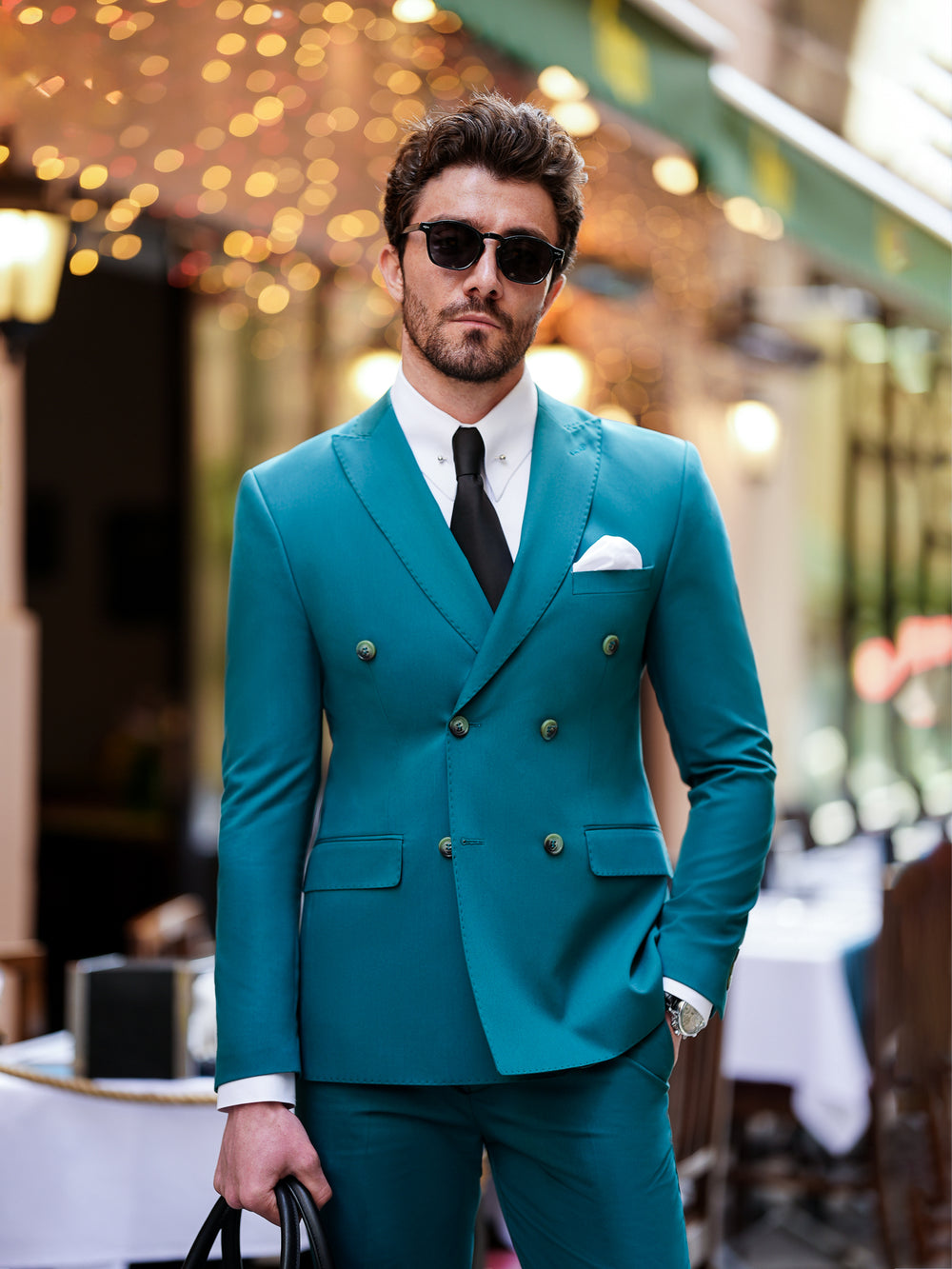 XAYWEAR teal double-breasted suit for men with black tie and white shirt worn by man with sunglasses
