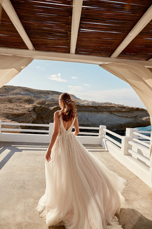 Elegant XAYWEAR wedding dress with flowing tulle skirt and open back design in outdoor setting