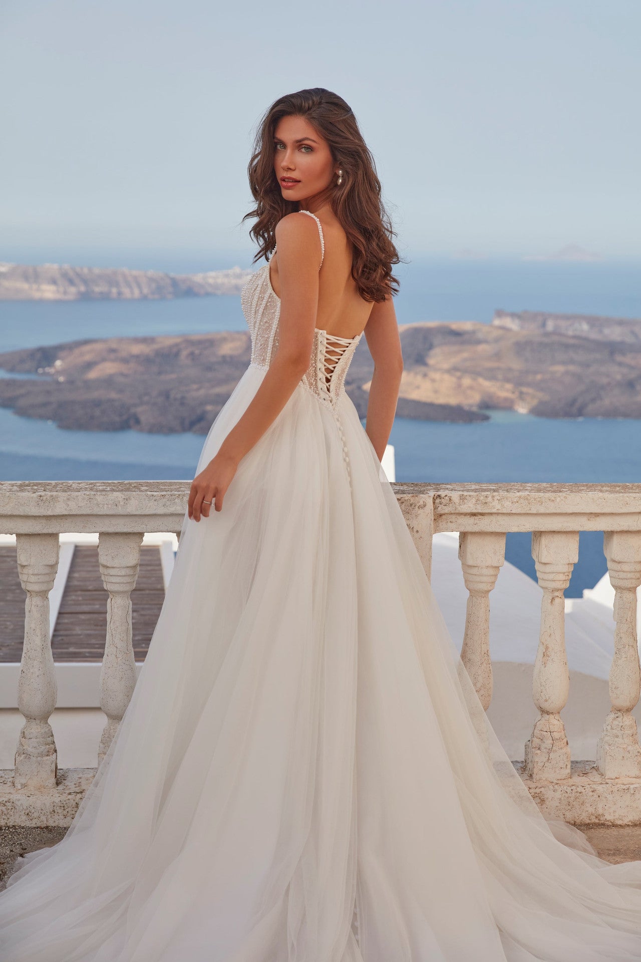 XAYWEAR elegant wedding dress gown with lace-up back and flowing tulle skirt overlooking ocean view