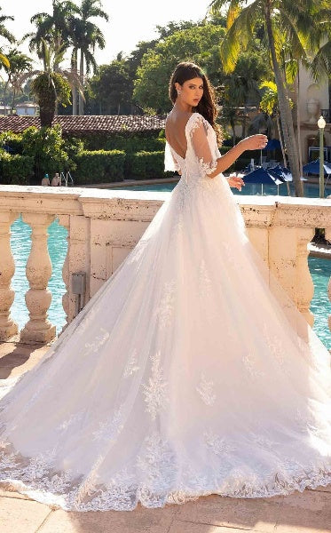 XAYWEAR elegant wedding dress with lace detailing and long train worn outdoors near pool