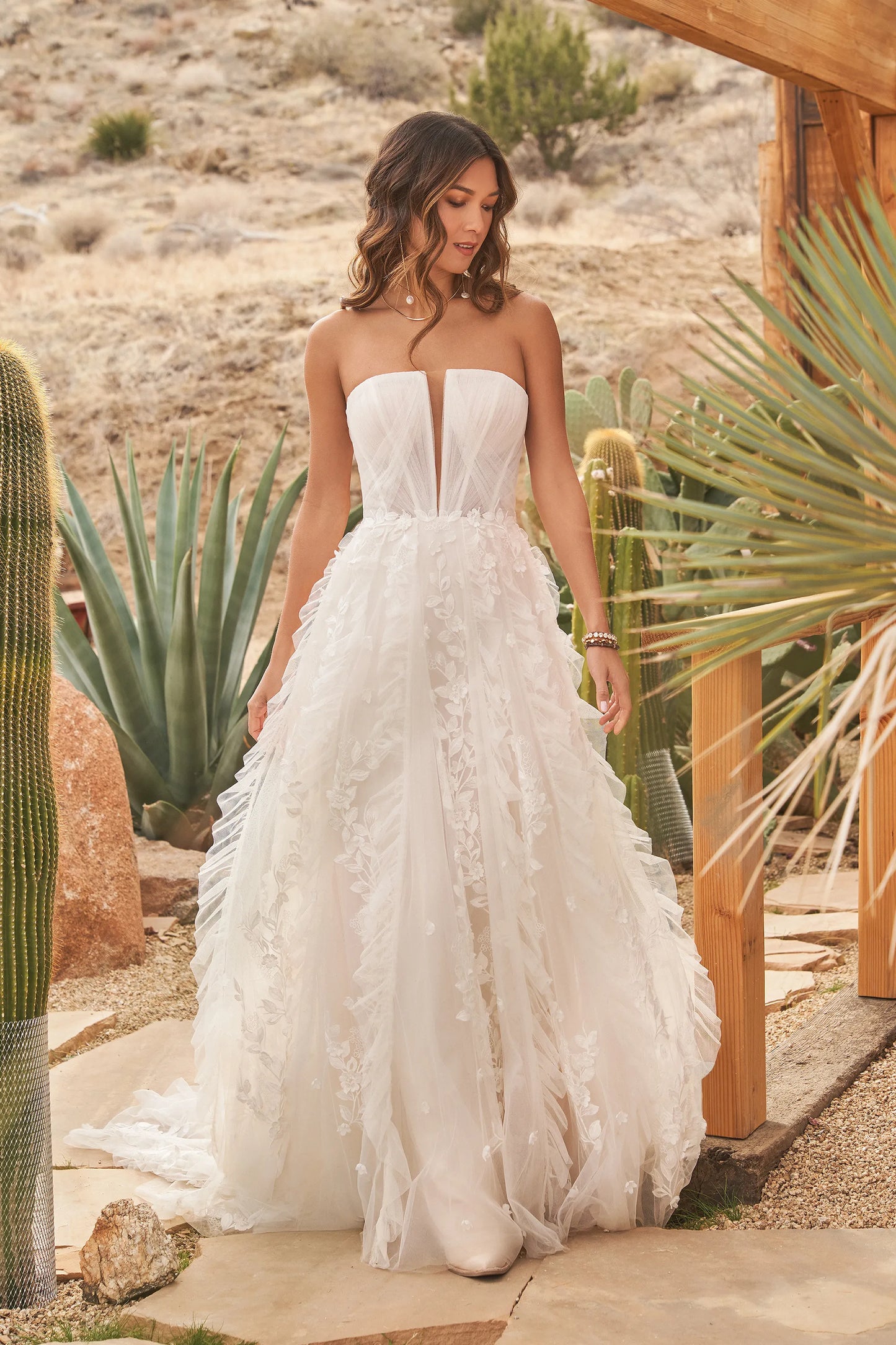 XAYWEAR strapless gown wedding dress with floral appliques and flowing skirt outdoors