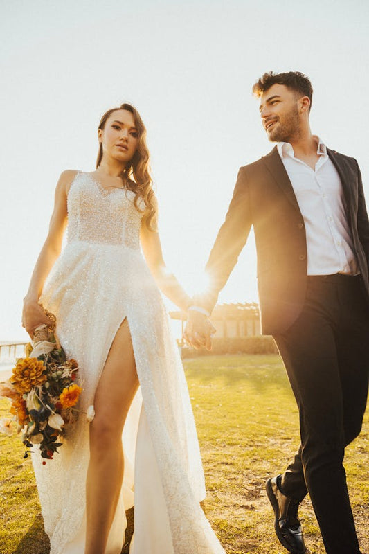 XAYWEAR elegant wedding gown with lace details and thigh-high slit worn by bride holding bouquet
