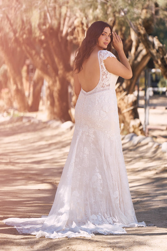 XAYWEAR elegant wedding gown with lace details and open back design flowing on outdoor path