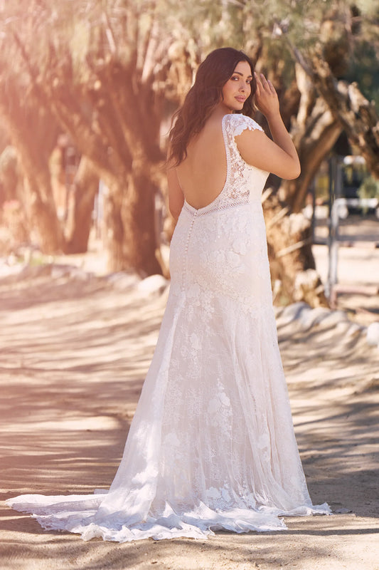 XAYWEAR elegant wedding gown with lace details and open back design flowing on outdoor path