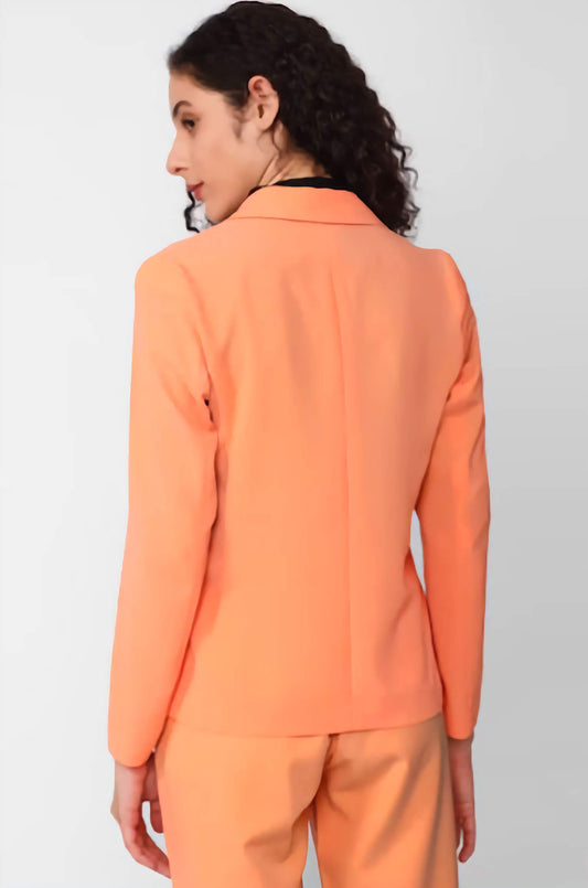 XAYWEAR peach suit jacket and pants viewed from the back as a women business outfit