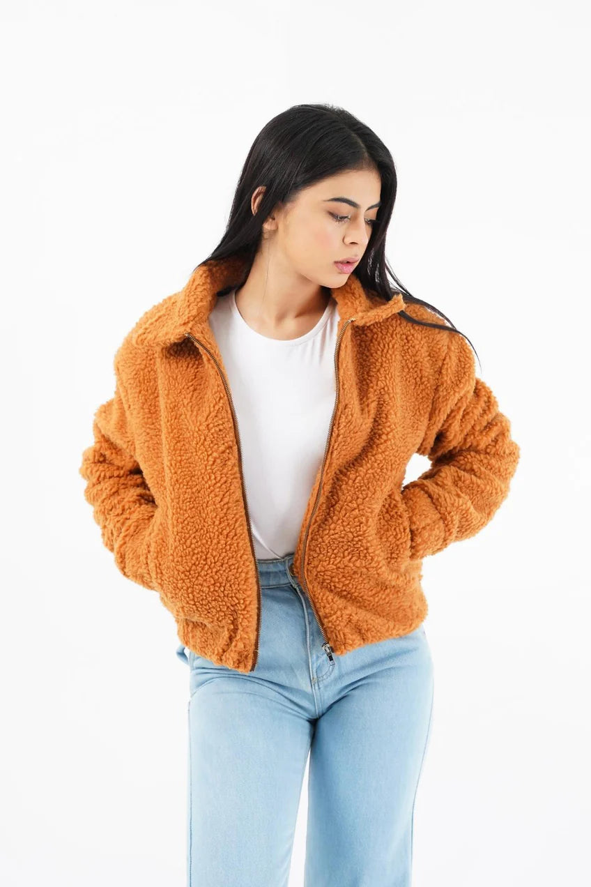 Trendy women faux fur jacket in orange with a zip-up front and side pockets for casual wear