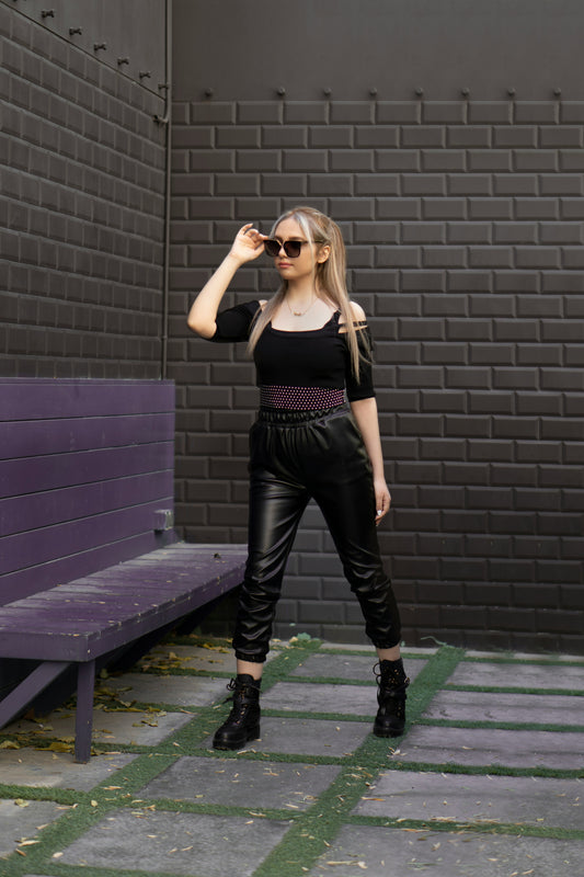 Woman wearing XAYWEAR Faux Leather Joggers for Women Trendy Comfort with black top and boots