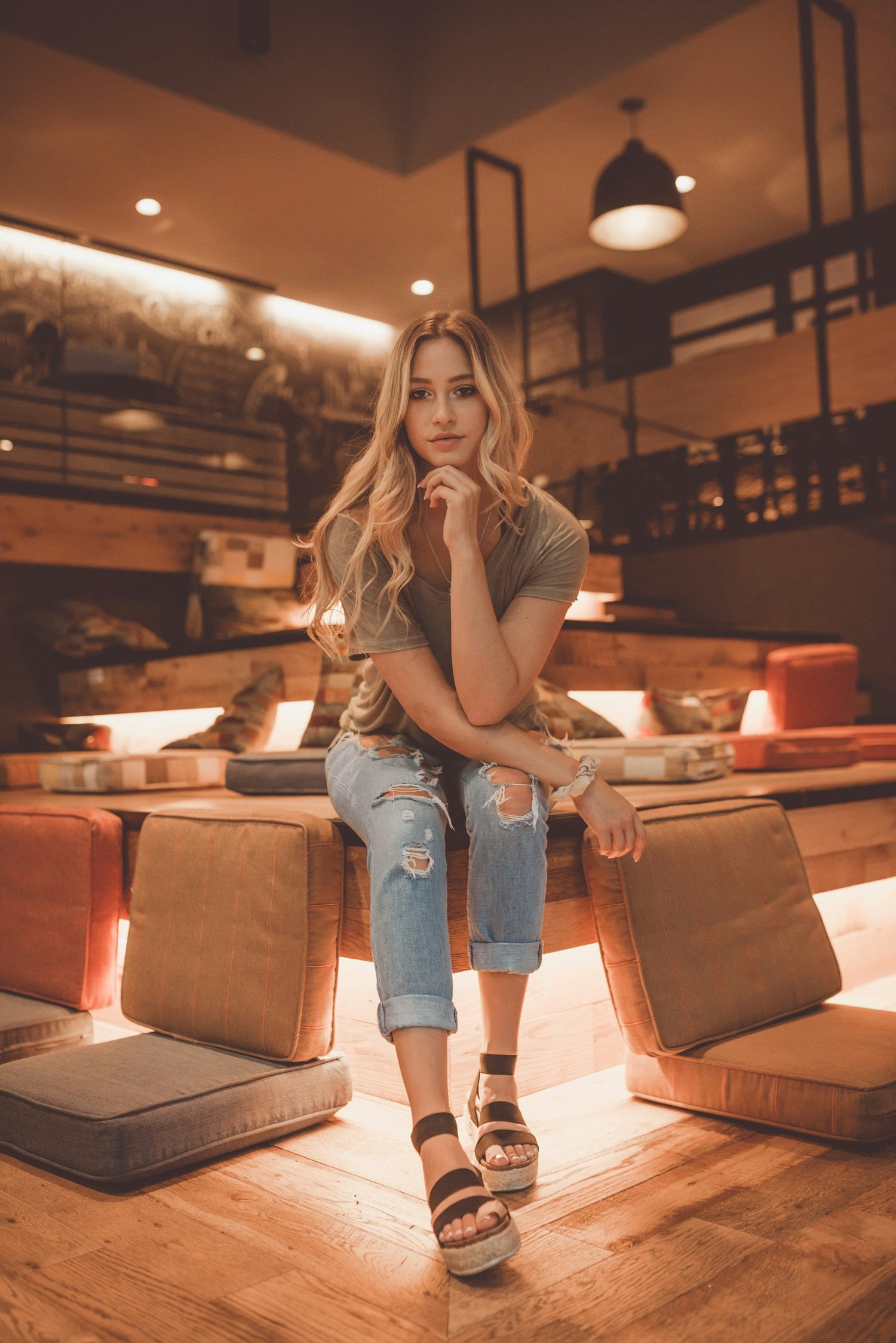 Stylish woman wearing casual top and ripped jeans, perfect look for a versatile women wardrobe