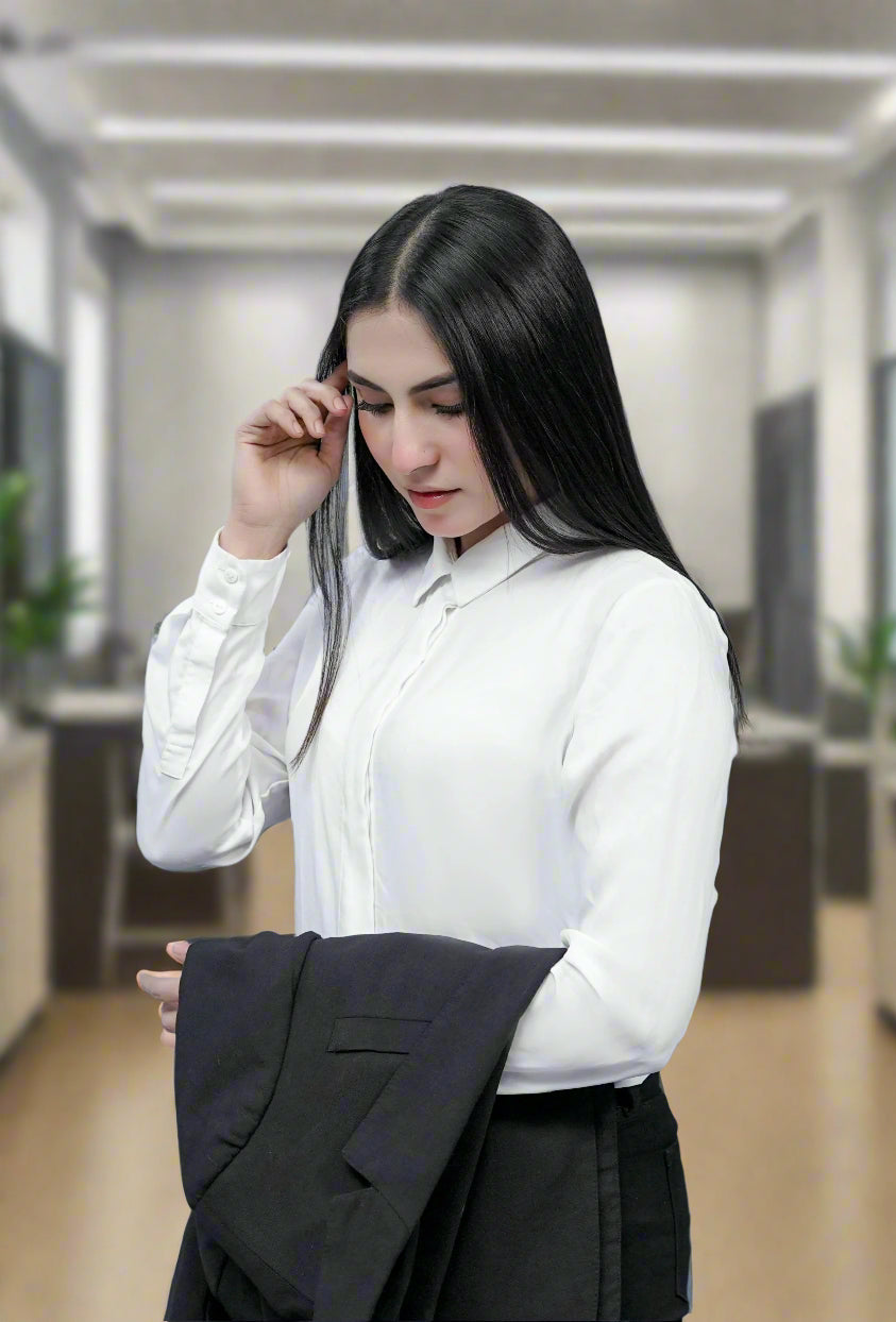 Confident woman in women formal wear orange blazer and white shirt working on laptop inside a car