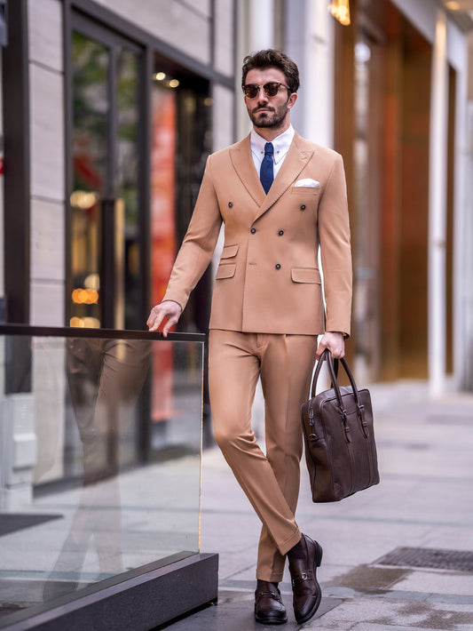 Man wearing a tan double-breasted suit for men by XAYWEAR with blue tie and brown leather shoes