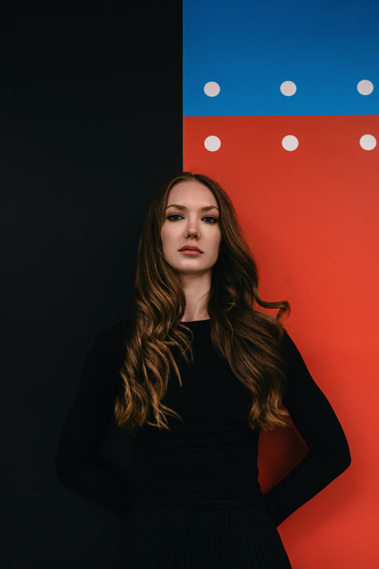 Stylish black formalwear for women featuring a fitted design and elegant long sleeves