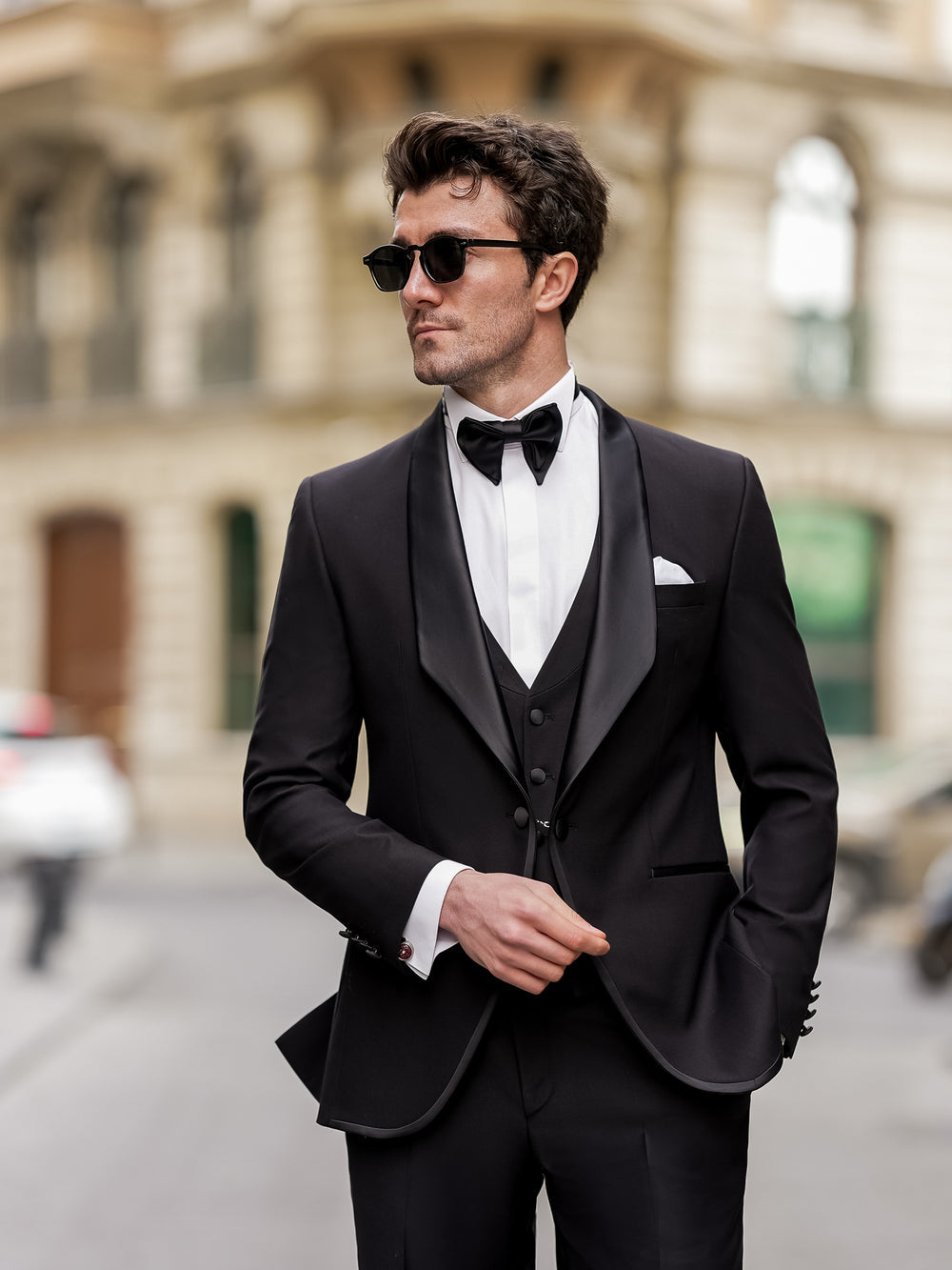 XAYWEAR elegant black men suit with satin lapel, bow tie, and white dress shirt on model outdoors