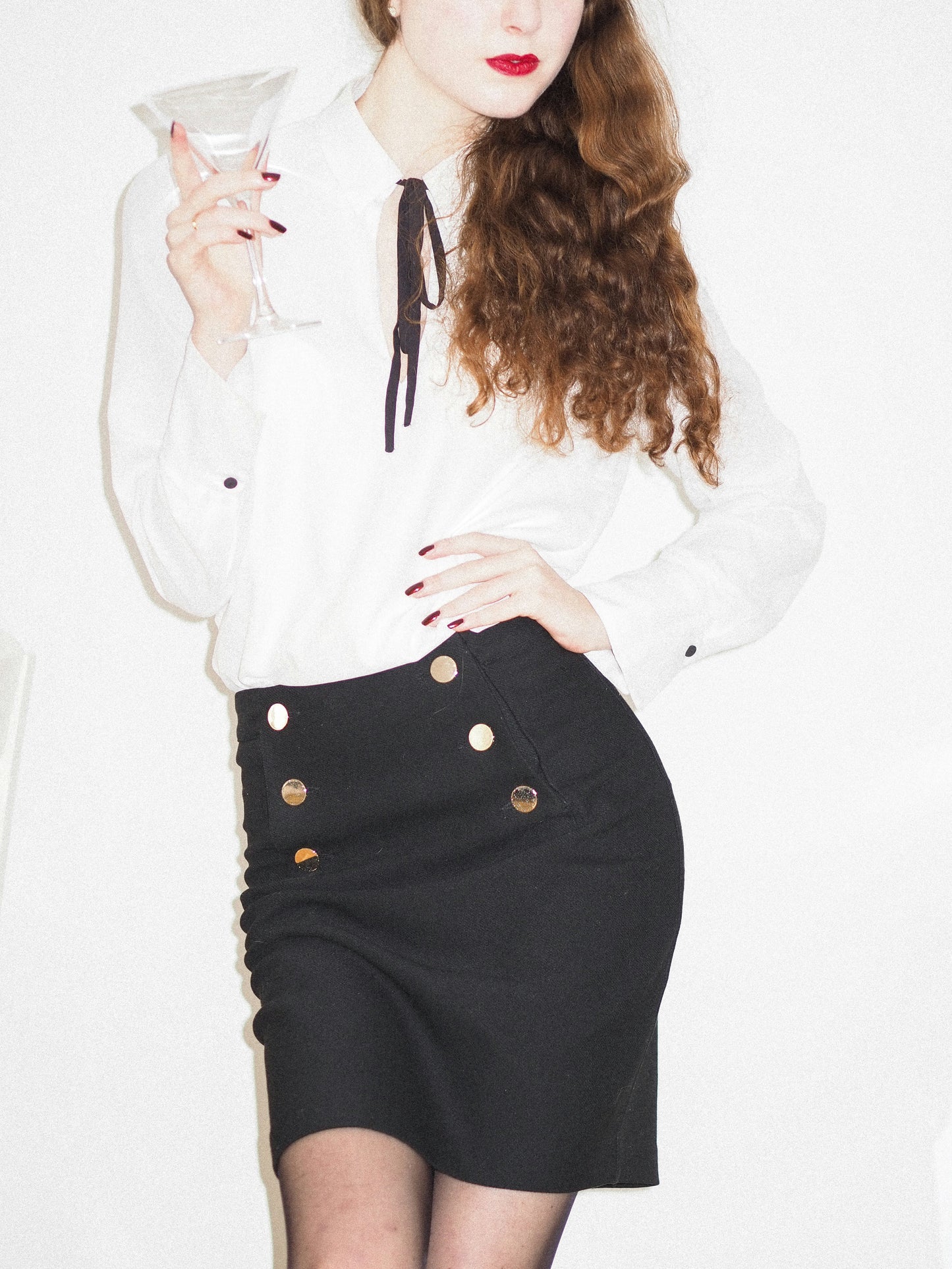XAYWEAR black skirt mini length with decorative buttons, styled with white blouse for a chic look