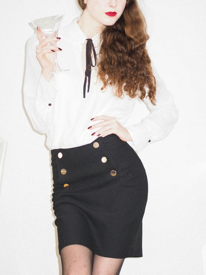 XAYWEAR black skirt mini length with decorative buttons, styled with white blouse for a chic look