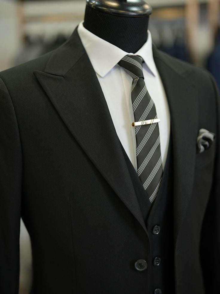 XAYWEAR black three piece suit with striped tie and white dress shirt on mannequin
