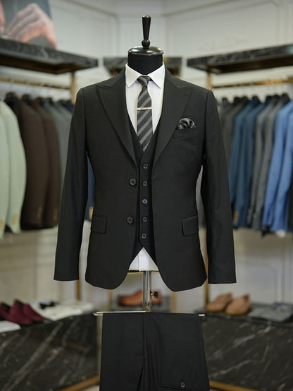 XAYWEAR black tailored three piece suit with vest and striped tie on mannequin