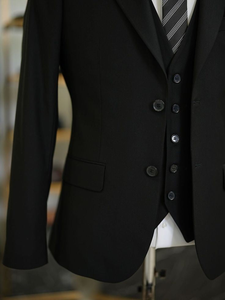 XAYWEAR black three piece suit with buttoned vest and striped tie for formal occasions