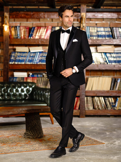 XAYWEAR black suit for men with bow tie and white pocket square in stylish library setting