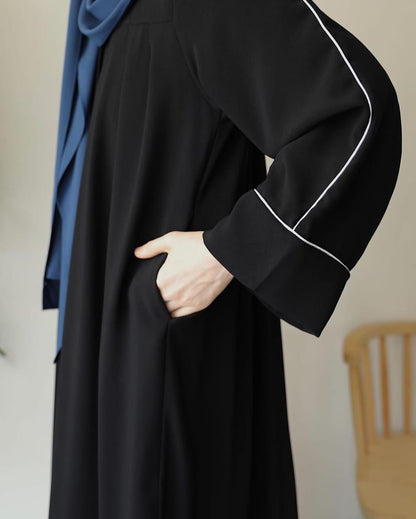 Stylish black zip neck abaya with elegant sleeves and side pocket detail