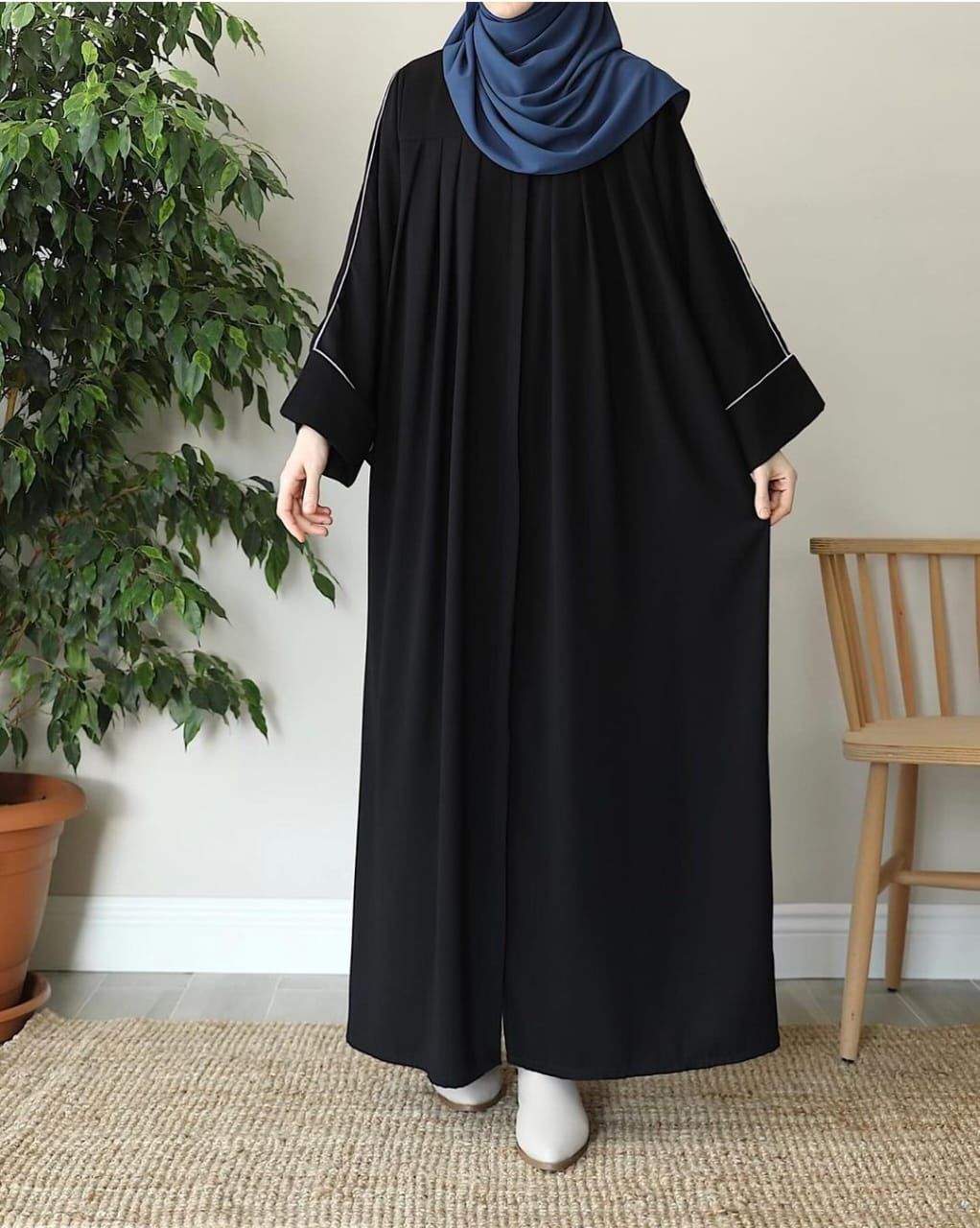 Elegant black zip neck abaya with wide sleeves and contrasting stitching for stylish modest wear