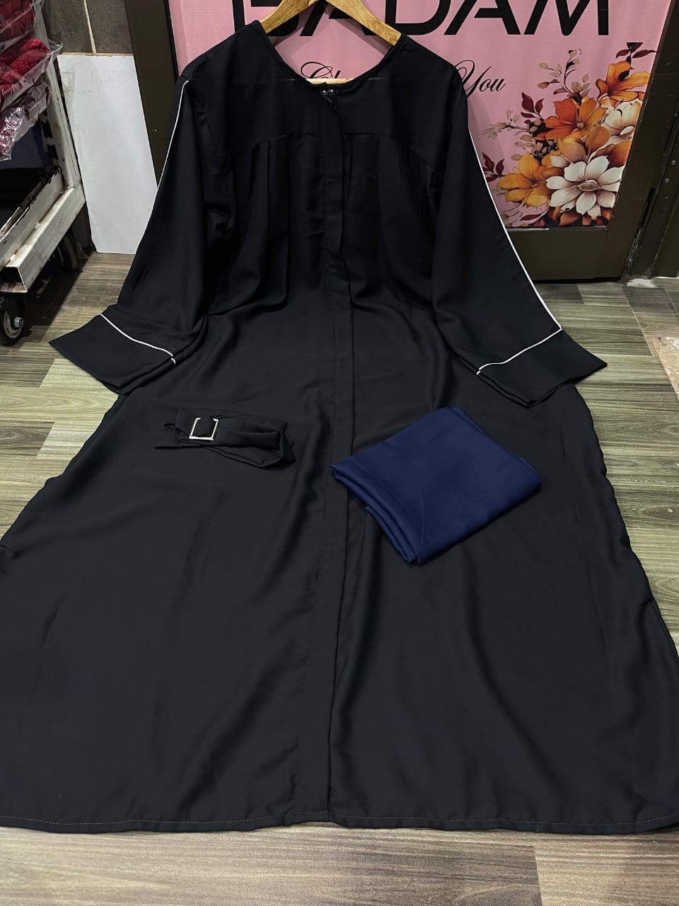XAYWEAR black zip neck abaya with elegant design, featuring a matching belt and soft fabric