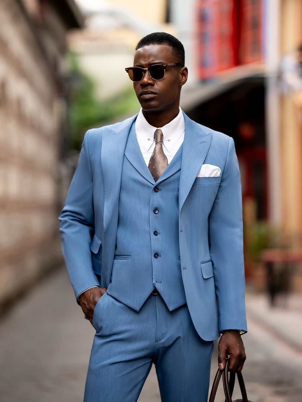 XAYWEAR stylish blue suit for men with vest, white shirt, and tie worn by man with sunglasses