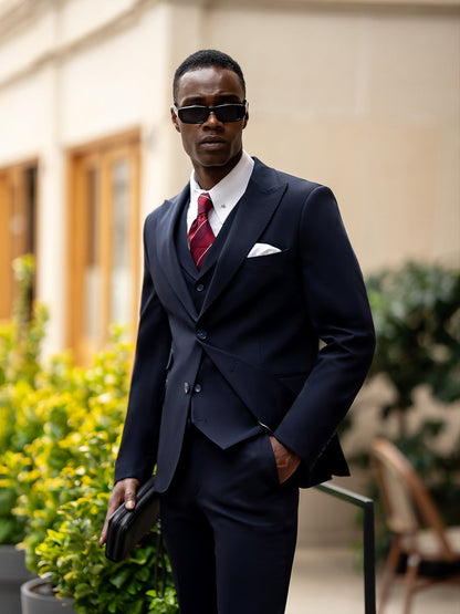 XAYWEAR stylish blue suit for men with a white shirt and red tie worn by a man with sunglasses