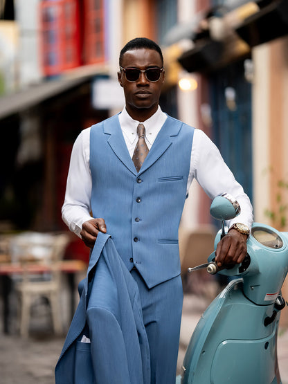 Stylish blue suit for men by XAYWEAR worn with white shirt and brown tie near vintage scooter