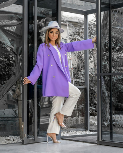 Stylish purple XAYWEAR WOMEN COAT worn with white pants and hat in modern glass doorway
