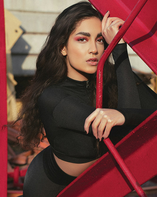 XAYWEAR black long sleeve crop top women gym wear modeled outdoors with red gym equipment