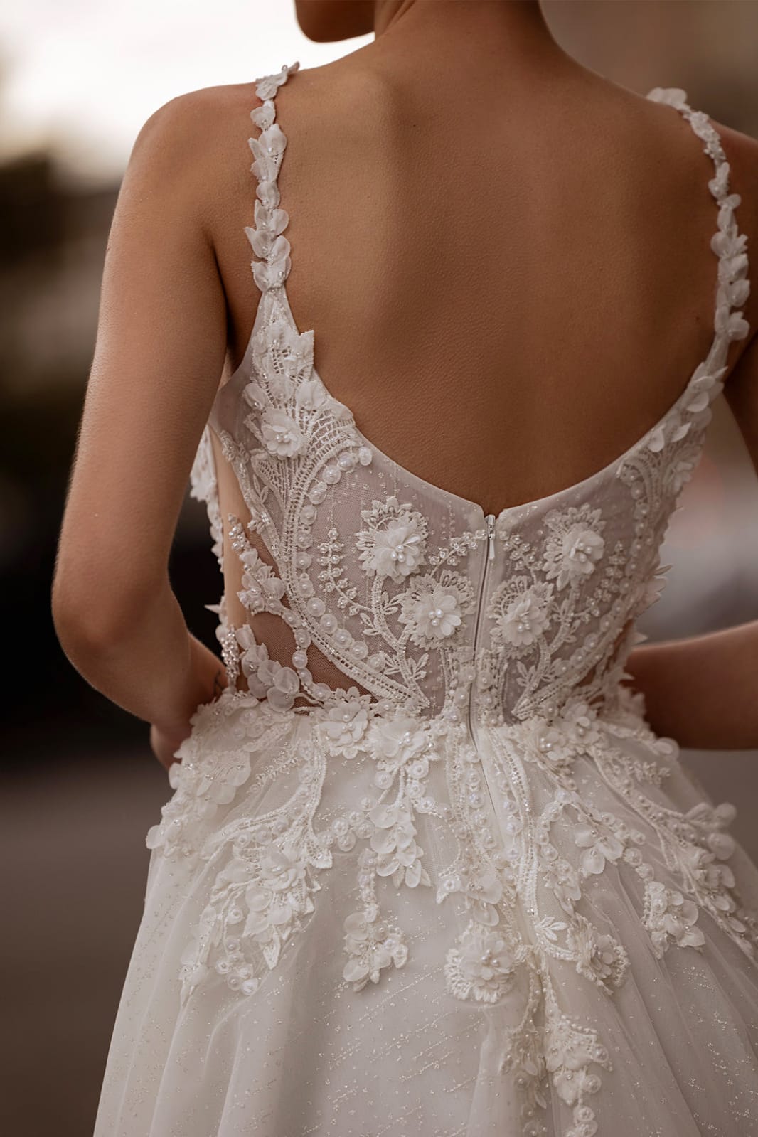 Back view of XAYWEAR white bridal gown with intricate lace detailing and floral embroidery
