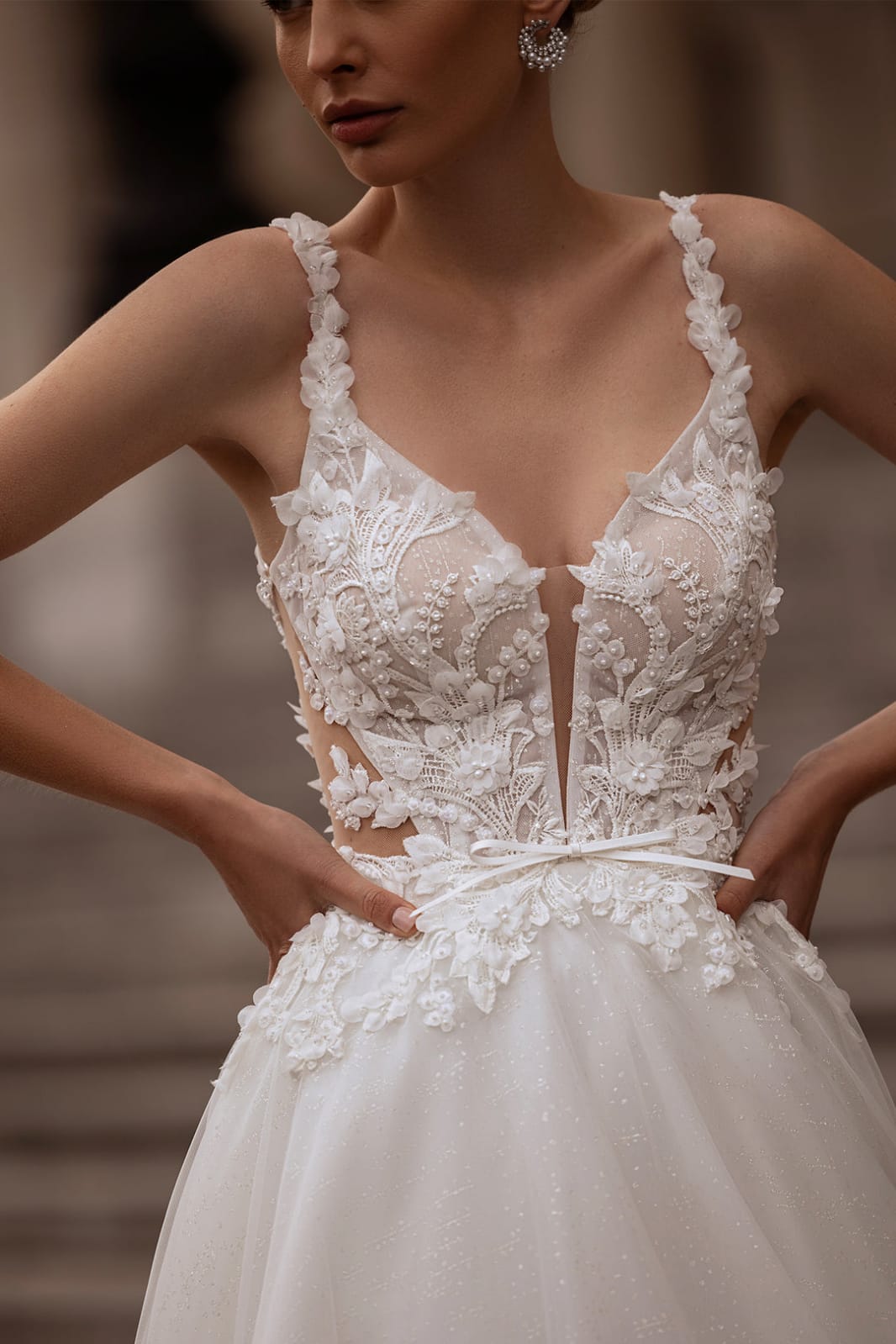 XAYWEAR bridal gown with intricate lace detailing and deep V neckline on fitted bodice