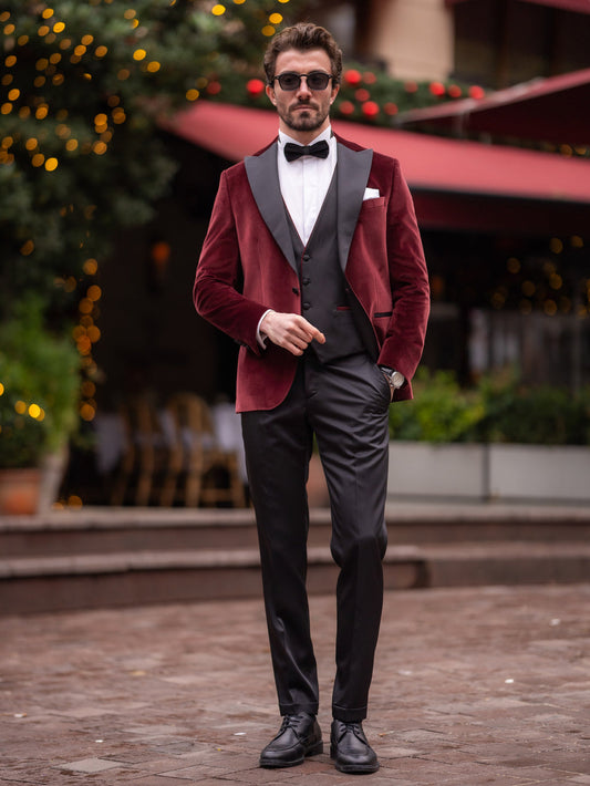 Stylish burgundy velvet blazer men paired with a black vest and bow tie for formal occasions